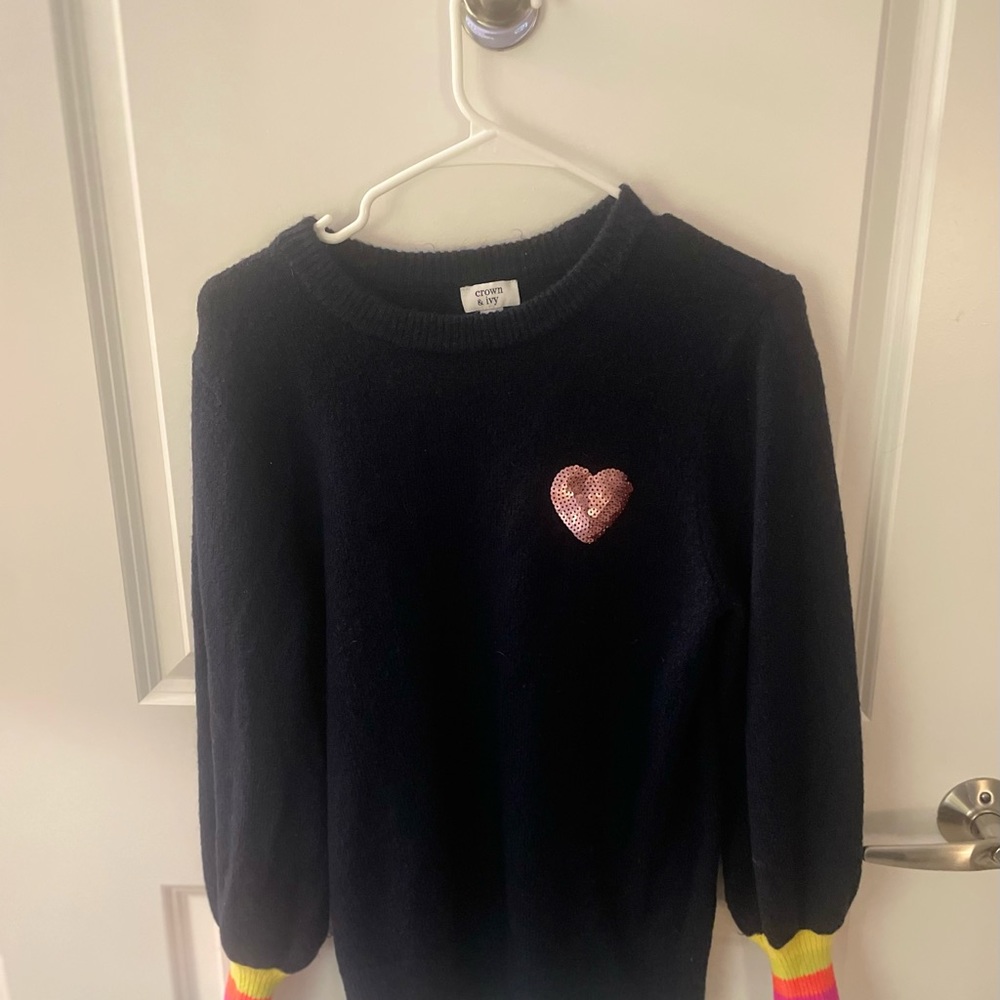 Embellished with a pink sparkly heart and rainbow cuffs